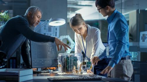 Three researchers around a table working on technology innovation in a lab; Maryland Innovation Initiative program supports researchers and innovators in bringing their ideas to market