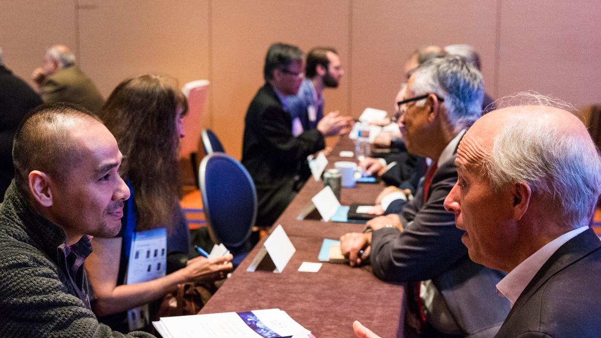 Photo of people sitting and chatting at a conference