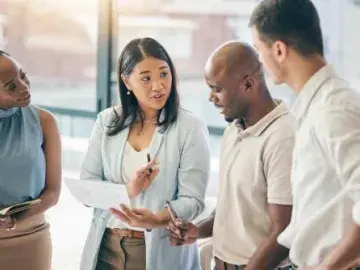 several people discussing the content of a tablet computer