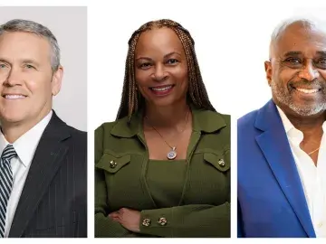 Three smiling business professionals in portraits, side by side on a white background