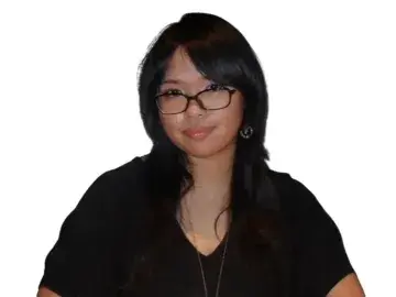 Portrait photo of a woman with glasses and long dark hair on a white background.