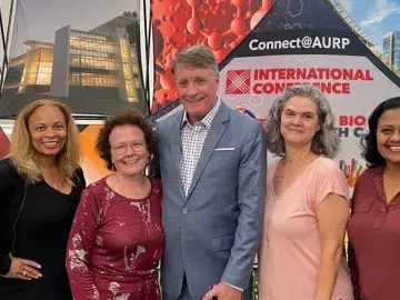 five people standing in front of AURP 