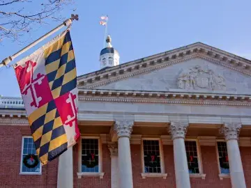 Close up view of Maryland state flag in front of the capitol state house in Annapolis, MD.