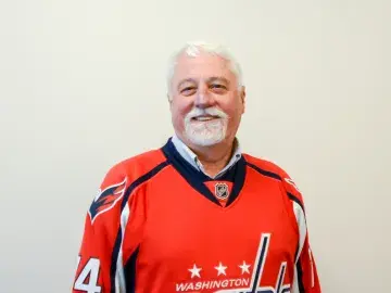 William L. Bernard in a red Washington Capitals hockey jersey against a plain background.