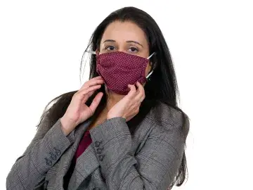 Jigita Patel in gray blazer adjusting a maroon knit face mask, on white background