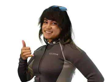 Brittney Jackson in a gray wetsuit giving a thumbs-up against a white background