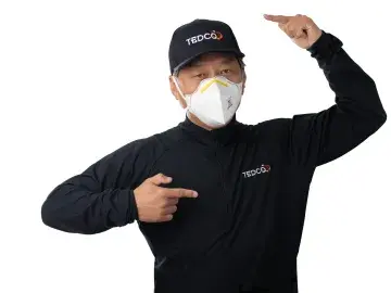 Jean-Luc Park, masked in black uniform points at his cap and chest logo on white background.