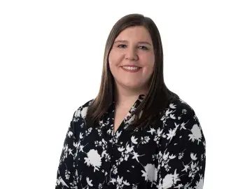 Cassy Haber in black floral blouse against a white background