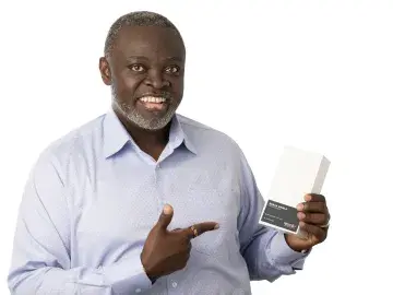 Benga Erinle in blue shirt points to a blank card he is holding.