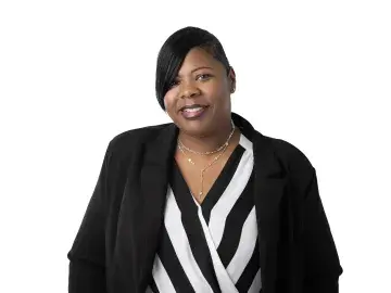April Davis-Hurtt in black blazer and striped blouse on white background