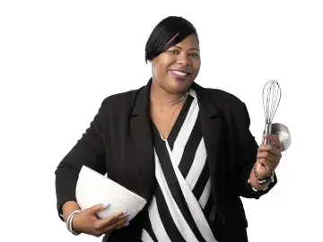 April Davis-Hurtt in blazer holding a whisk and a bowl against a white background