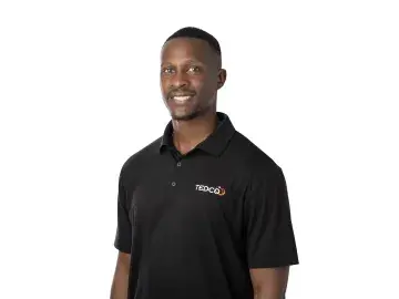 Claudius Taylor in black polo shirt on white background.