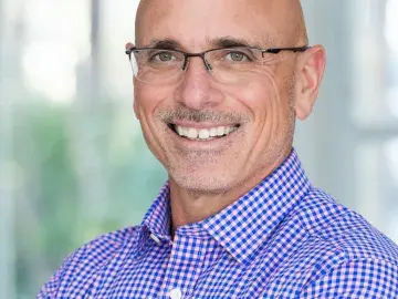 David Tohn with glasses in a blue checkered shirt