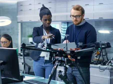 Makerspace: Innovative entrepreneurs working with a robotic arm