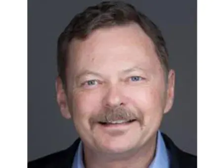 Kenneth Porter, PhD, MBA with mustache in a headshot against a gray background.
