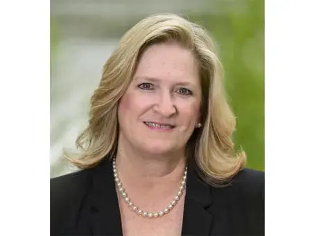 Renée M. Winsky smiling in black blazer and pearl necklace.