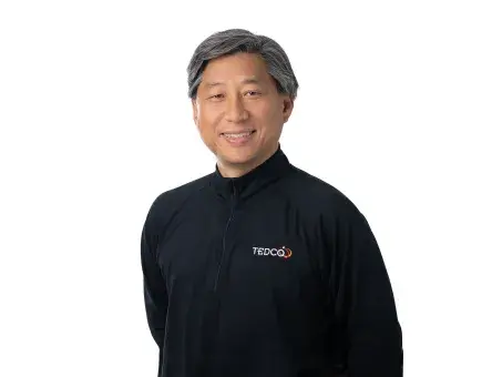 Jean-Luc Park in black jacket with Nvidia logo, standing against a white background.