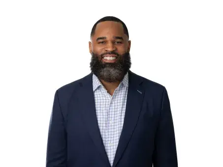 Jason Harris in a navy blazer on a white background.