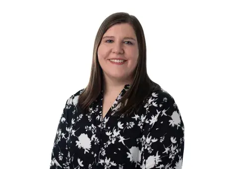 Cassy Haber in black floral blouse against a white background