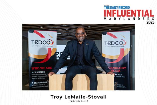 Troy LeMaile-Stovall sitting in front of TEDCO Banners with Influential Marylanders logo in top right corner