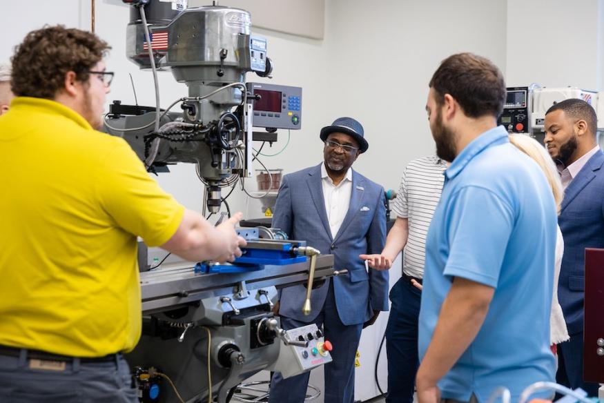 TEDCO CEO TROY LEMAILE-STOVALL (SECOND FROM LEFT) TOURS THE NAWCAD FACILITY.